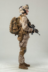 Soldier in camouflage holding rifle