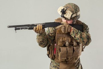 Fototapeta premium Soldier in camouflage holding rifle