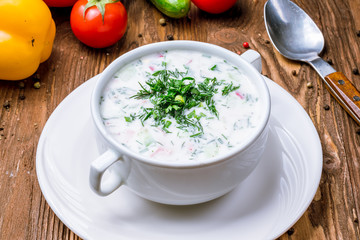 Okroshka on kefir on wooden table