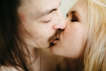 Portrait of a sexy young couple kissing.