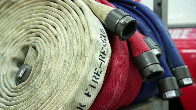 4K detail shot of firehoses ready to go, on the side of a fire truck.