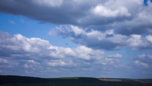 Quickly floating white clouds in cloudy day