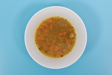 Lentil soup with carrots on a blue