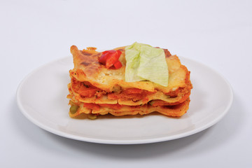 Lasagna with vegetables on a white