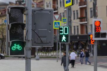 Close up of traffic lights and blurred pedestrians behind in Moscow center, Russia