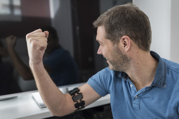 Smiling man with wearable at his arm