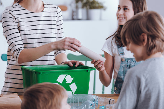 Mother teaching kids segregating waste