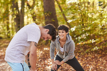 Couple stretching in autumn forest