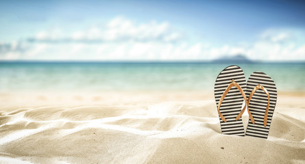 flip flops on beach and summer time  - obrazy, fototapety, plakaty