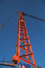 Close-up of crane in a construction area at sunset and blue sky in Tielt. Charming and quiet...