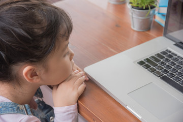 Fototapeta na wymiar Little kid playing with laptop