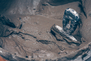 Spatula in a bucket with tile glue, facing tile mounting works