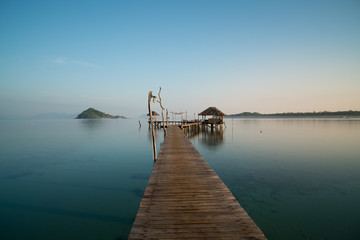 Wooden pier between sunset in Phuket, Thailand. Summer, Travel, Vacation and Holiday concept.