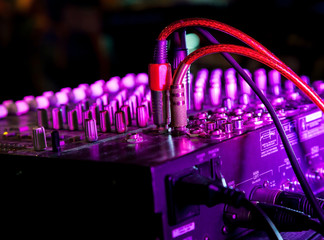 Music Mixer at nightclub with connected wires