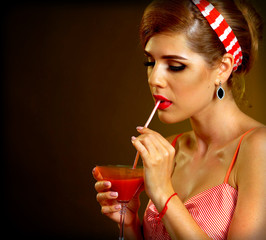 Pin up girl drink bloody Mary cocktail. Pin-up retro female style. Girl wearing red dress seduces men. How to succeed in your personal life. Sexy girl in nightclub.