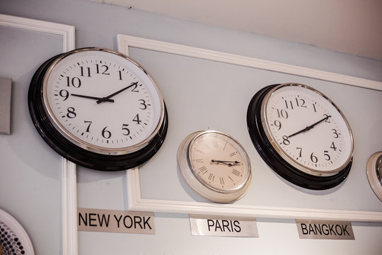 international clock with different time zone for New York, Paris and Bangkok are hang on the wall