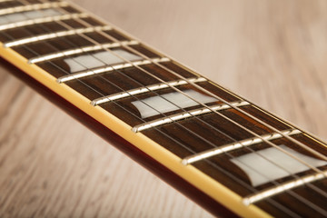 Fototapeta premium Old beautiful electric guitar on a background of wood.