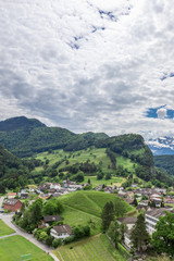 Fototapeta na wymiar View of the city among the mountainous Alps in Liechtenstein.