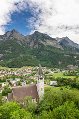 Fototapeta na wymiar Church in Alps. Old church in Liechtenstein Alps. Mountains view