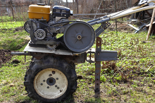Compact agricultural machinery for garden on wheel drive with petrol engine