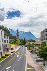 Street in Liechtenstein with Alps background.