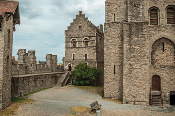 Fototapeta premium Stone watch-tower, walls and flags inside the Gravensteen Castle at Ghent. In addition to intense cultural life, the city is full of Gothic buildings and Flemish style architecture. Northern Belgium.