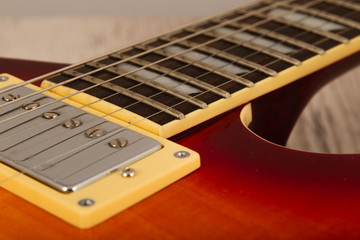 Fototapeta na wymiar Old beautiful electric guitar on a background of wood.