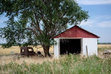 Old shed with rusted car