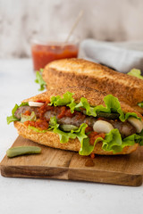 Hot dog with sausage grill, fresh vegetables and sauce.