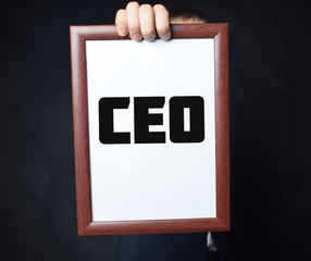 In the hands of a businessman a frame with the inscription:CEO