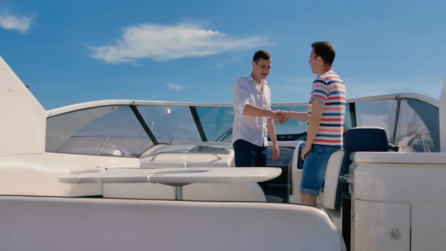 Handsome man shake hands with captain yacht