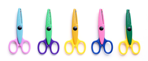 Five children's pinking shears in a row