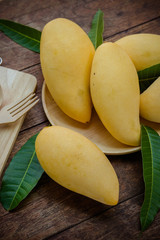 sweet yellow mango fruit  on wood table , ready to eat for healthy , fruit on summer
