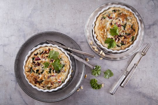 Puff pastry quiche with chard, bacon, goat's cheese and pine nuts
