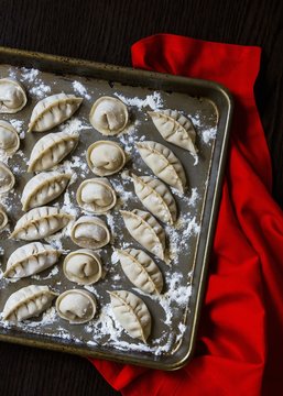 Fresh hand-made Chinese dumplings on a baking tray