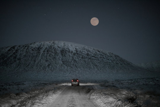 Full moon in a snowy road