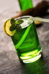 Khus Sharbat or Vetiver Drink served in a glass with Mint and Lemon slice, selective focus