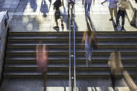 Overhead blurred people walking up and down the steps