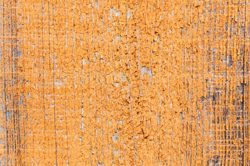 The orange or yellow wood texture with natural patterns. Cracked paint.Surface of old wood plank with copy space.