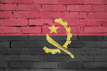 Angola flag is painted onto an old brick wall