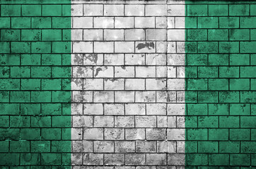 Nigeria flag is painted onto an old brick wall