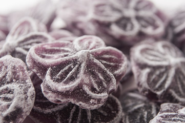 closeup of traditional purple candies in shaped flower texture