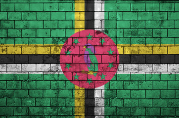 Dominica flag is painted onto an old brick wall