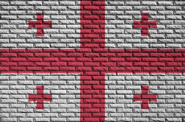 Georgia flag is painted onto an old brick wall