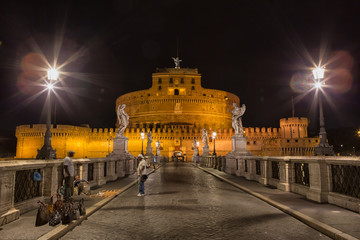 Fototapeta na wymiar Castel Sant'Angelo (Hadrian's Tomb) in Rome, Lazio, Italy seen from the Ponte Sant'Angelo illuminated at night. 
