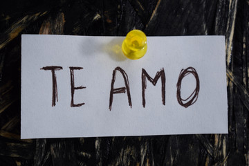 te amo  written in Spanish, means to i love you, on a white sheet of paper.