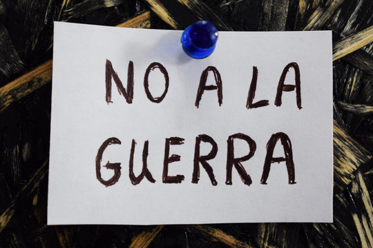 no a la guerra written in Spanish, means to not to the war, on a white sheet of paper.