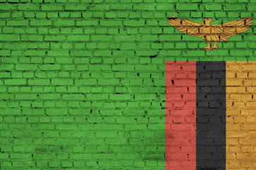 Zambia flag is painted onto an old brick wall