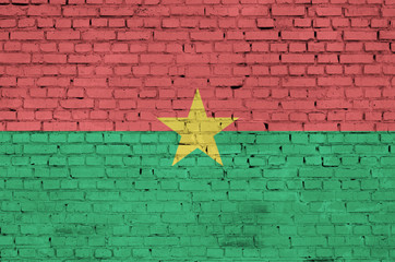 Burkina Faso flag is painted onto an old brick wall