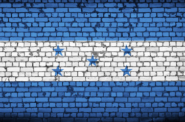 Honduras flag is painted onto an old brick wall
